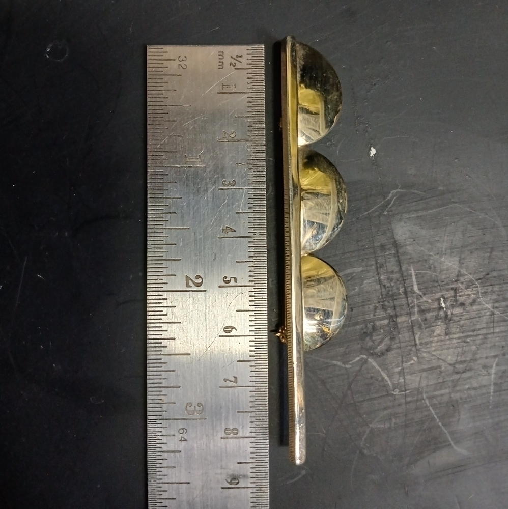 Long goldtone brooch
